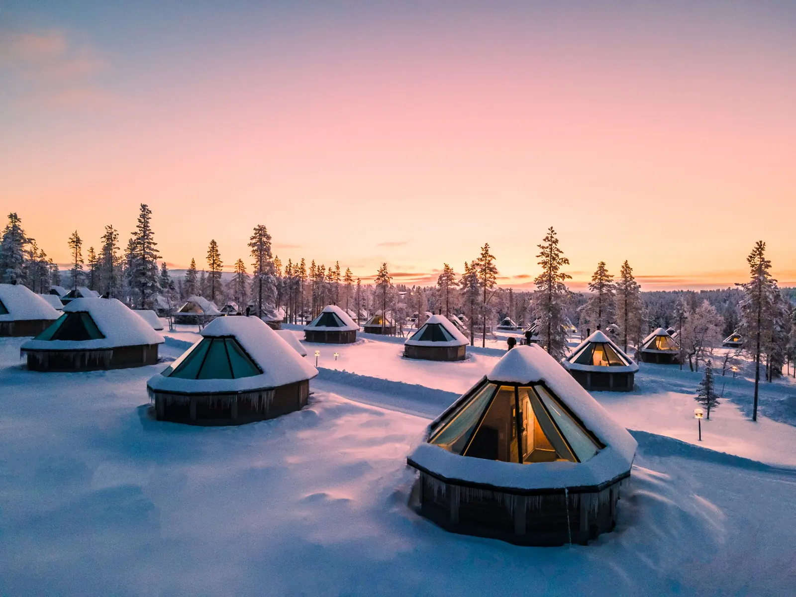 Snow-covered aurora cabins at Northern Lights Village