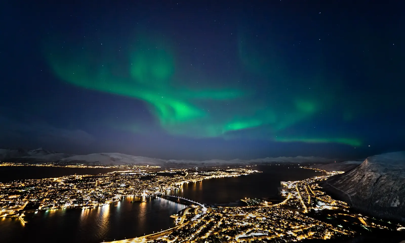 Northern Lights above Tromsø, its harbour and mountains