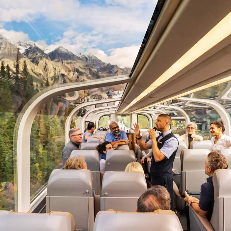 Passengers dining beside the windows aboard Rocky Mountaineer