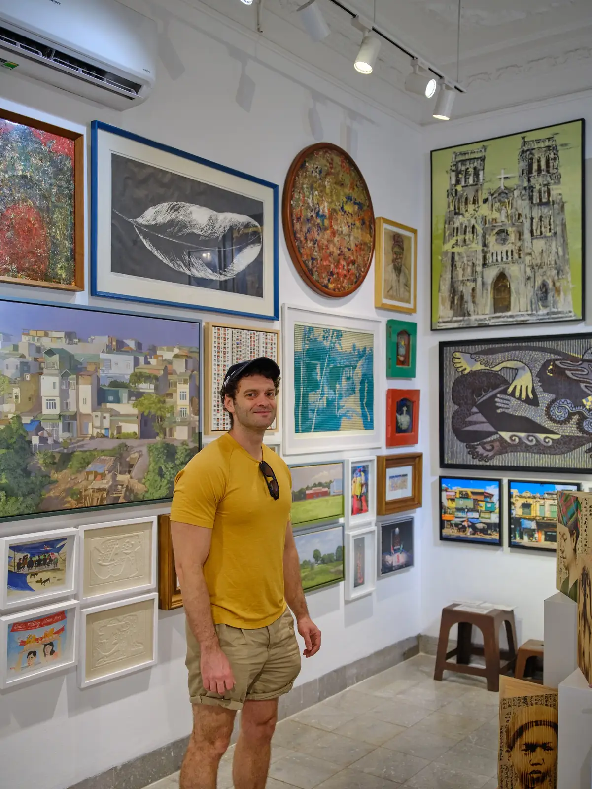 Joshua Zukas viewing paintings in an art gallery
