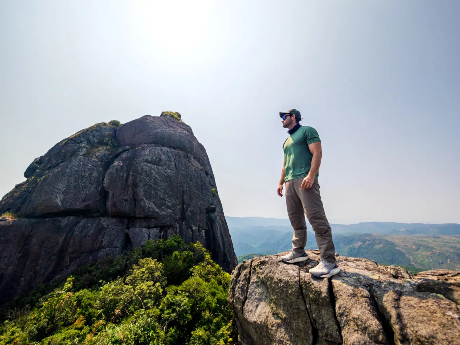 Joshua Zukas standing on a rocky mountain summit