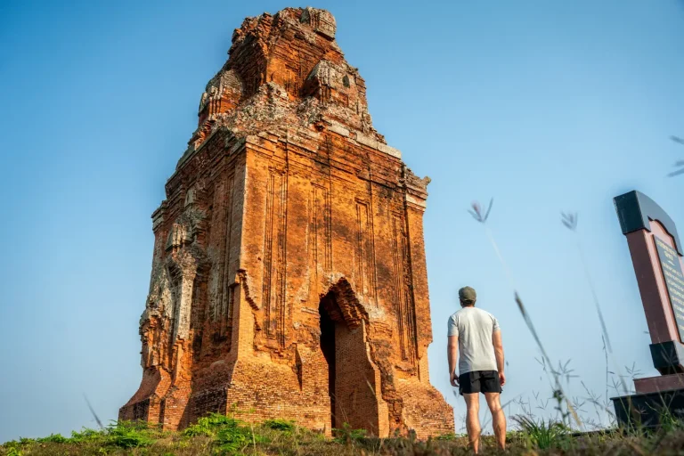 Joshua Zukas beside the brick tower at Phu Loc Temple