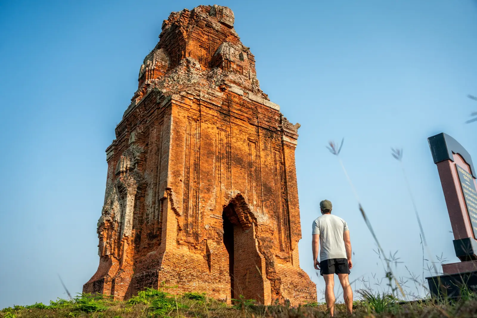 Joshua Zukas beside the brick tower at Phu Loc Temple
